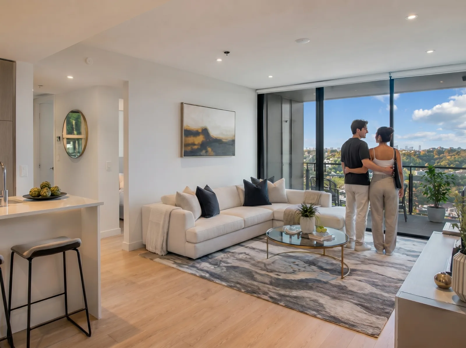 Young couple enjoying the view from their new apartment at The Grand